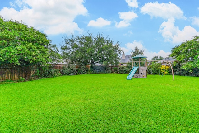703 Rock Creek Ct, Rosenberg, TX 77469 - fenced backyard featuring a playground
