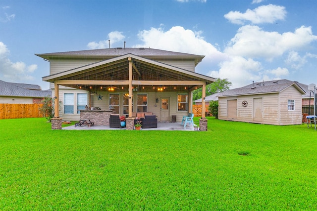 703 Rock Creek Ct, Rosenberg, TX 77469 - rear view of house with a patio, a fenced backyard, and an outbuilding