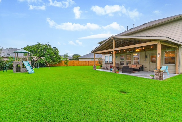 703 Rock Creek Ct, Rosenberg, TX 77469 - fenced backyard featuring a patio, an outdoor living space, and a playground