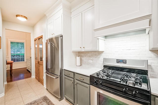 703 Rock Creek Ct, Rosenberg, TX 77469 - kitchen with stainless steel appliances, light tile patterned flooring, light countertops, and decorative backsplash
