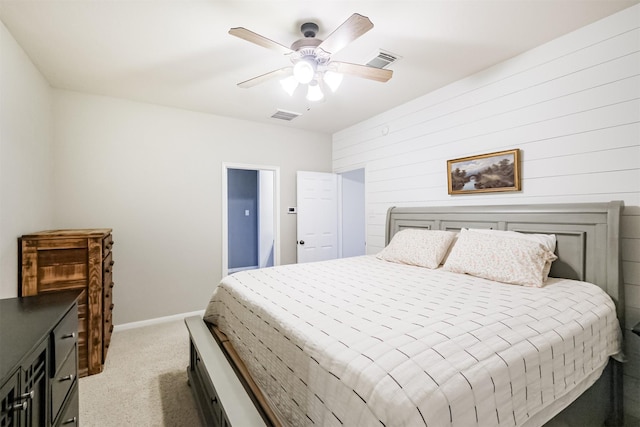 703 Rock Creek Ct, Rosenberg, TX 77469 - bedroom with light colored carpet, ceiling fan, and wood walls