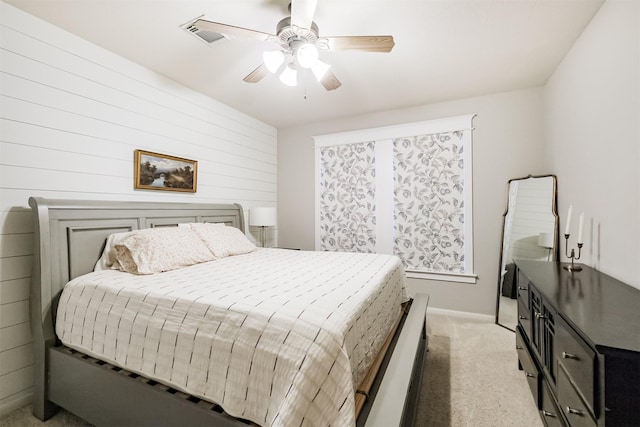 703 Rock Creek Ct, Rosenberg, TX 77469 - bedroom with light colored carpet, ceiling fan, and wood walls
