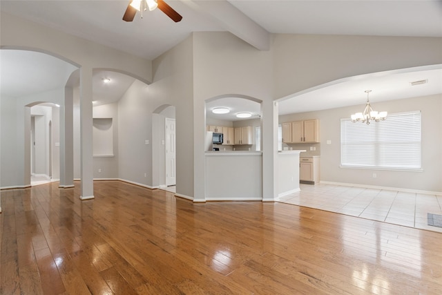 16306 Ancient Forest Dr, Humble, TX 77346 - unfurnished living room featuring ceiling fan, light wood-style floors, a chandelier, beamed ceiling, and high vaulted ceiling