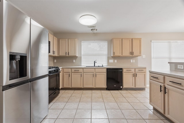 16306 Ancient Forest Dr, Humble, TX 77346 - kitchen with black appliances, light brown cabinetry, light countertops, and light tile patterned flooring