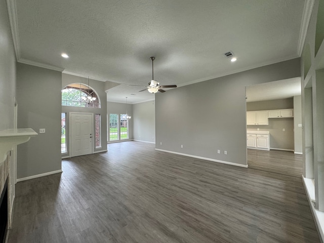 819 Companion Dr, Crosby, TX 77532 - unfurnished living room featuring a chandelier, ornamental molding, dark wood-style floors, ceiling fan, and a textured ceiling