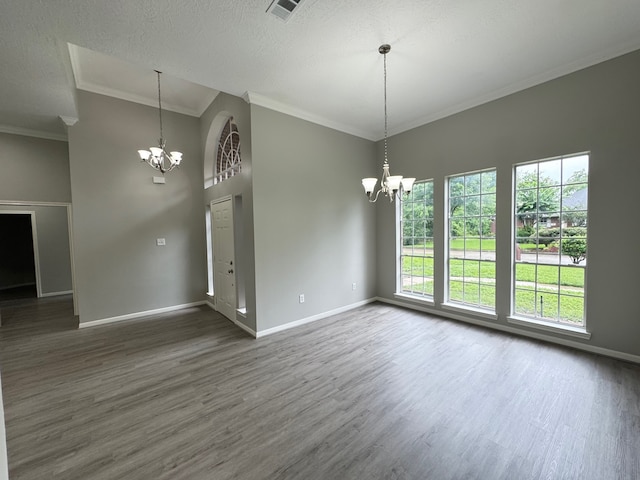 819 Companion Dr, Crosby, TX 77532 - unfurnished room with a chandelier, dark wood finished floors, crown molding, a high ceiling, and a textured ceiling