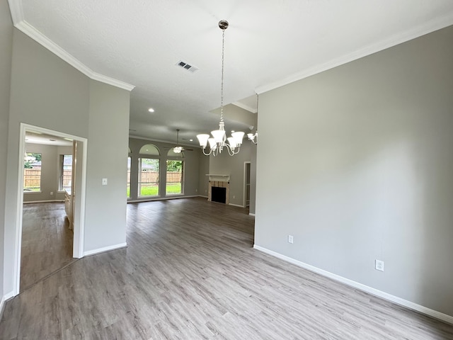 819 Companion Dr, Crosby, TX 77532 - unfurnished living room with ornamental molding, wood finished floors, a chandelier, and a fireplace