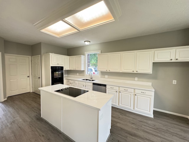 819 Companion Dr, Crosby, TX 77532 - kitchen featuring black appliances, dark wood-style floors, white cabinets, and a kitchen island