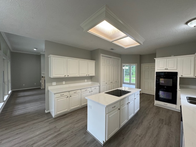 819 Companion Dr, Crosby, TX 77532 - kitchen featuring black appliances, a kitchen island, white cabinets, a textured ceiling, and crown molding