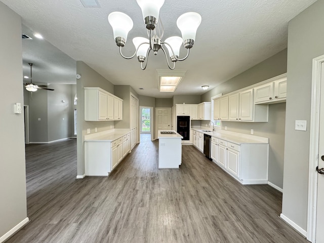 819 Companion Dr, Crosby, TX 77532 - kitchen featuring dishwashing machine, wood finished floors, a chandelier, and a kitchen island