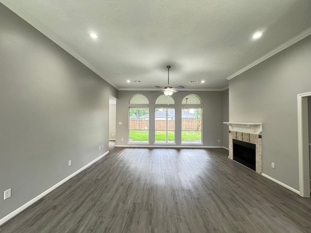 819 Companion Dr, Crosby, TX 77532 - unfurnished living room featuring dark wood-style flooring, a ceiling fan, a fireplace, ornamental molding, and recessed lighting