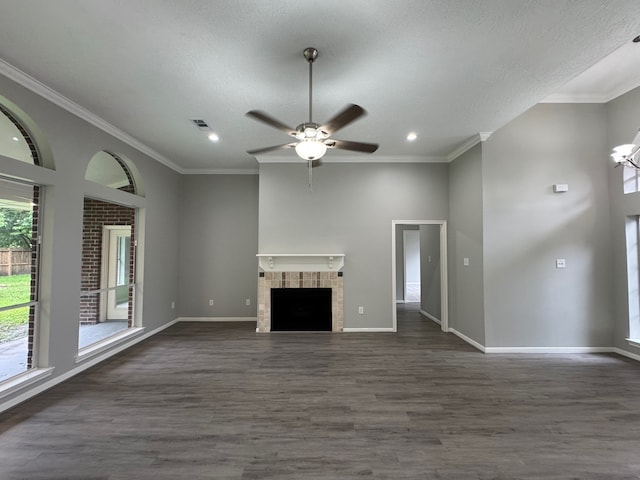 819 Companion Dr, Crosby, TX 77532 - unfurnished living room featuring dark wood-style flooring, ceiling fan, recessed lighting, a tile fireplace, and ornamental molding