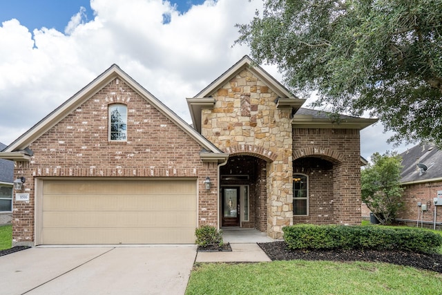 8506 Clarkman Ridge Ln, Cypress, TX 77433 - view of front facade featuring driveway, brick siding, and stone siding