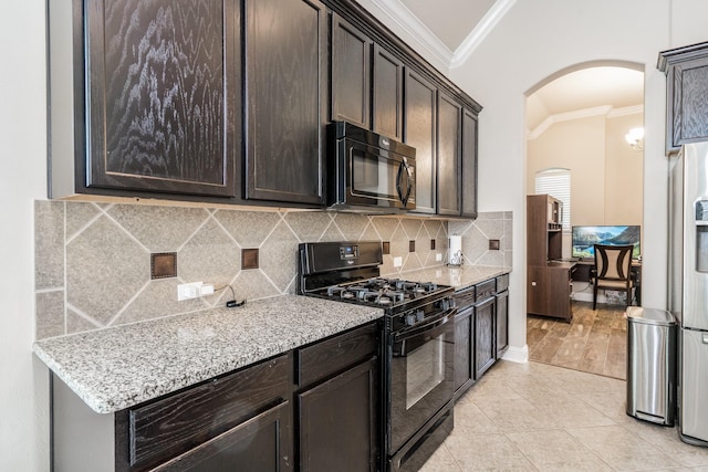 8506 Clarkman Ridge Ln, Cypress, TX 77433 - kitchen featuring black appliances, ornamental molding, arched walkways, dark brown cabinets, and tasteful backsplash