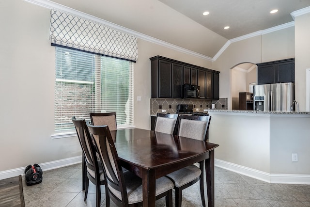 8506 Clarkman Ridge Ln, Cypress, TX 77433 - dining space featuring vaulted ceiling, ornamental molding, light tile patterned flooring, arched walkways, and recessed lighting