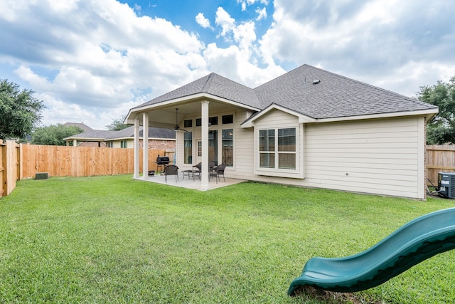 8506 Clarkman Ridge Ln, Cypress, TX 77433 - rear view of property featuring roof with shingles, a fenced backyard, a patio, and a playground