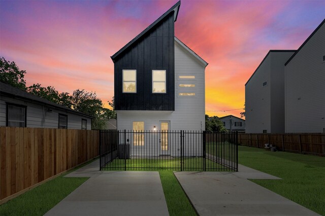 2475 Carmel St A/B, Unit A/B Houston, TX 77091 - contemporary house with board and batten siding, a patio area, and a fenced backyard