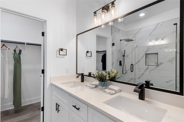2475 Carmel St A/B, Unit A/B Houston, TX 77091 - bathroom featuring a marble finish shower, double vanity, wood finished floors, recessed lighting, and a spacious closet