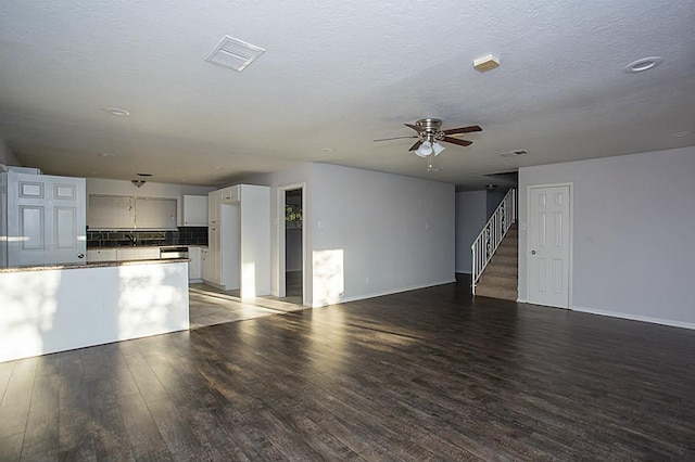 6407 Nuben St, Houston, TX 77091 - unfurnished living room with wood finished floors, ceiling fan, and stairway