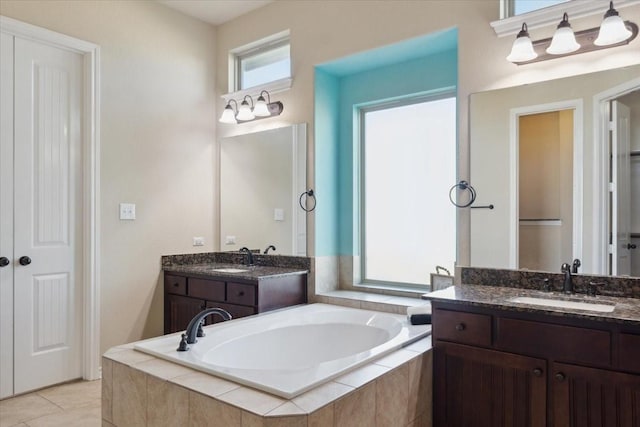2407 Thuesen Rd, Beasley, TX 77417 - bathroom featuring a garden tub, two vanities, and tile patterned floors