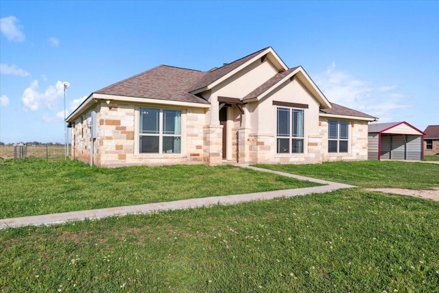 2407 Thuesen Rd, Beasley, TX 77417 - ranch-style home featuring stone siding, a front yard, a shingled roof, and stucco siding