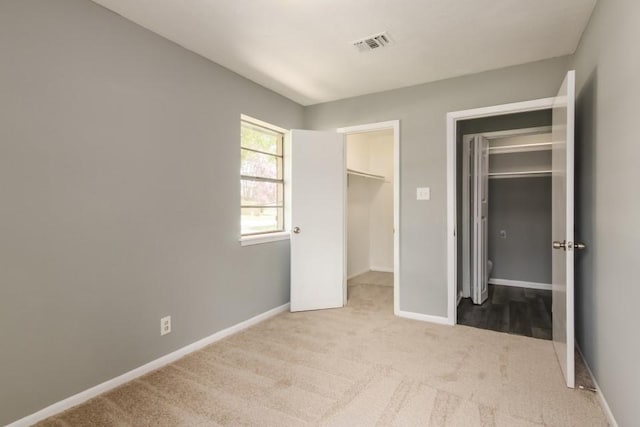 1314 Garrett St, Brenham, TX 77833 - unfurnished bedroom featuring carpet, a walk in closet, and a closet