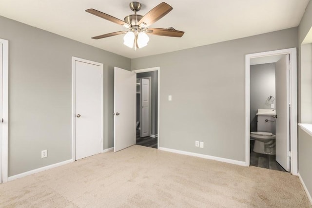 1314 Garrett St, Brenham, TX 77833 - unfurnished bedroom featuring carpet floors, ensuite bath, and ceiling fan