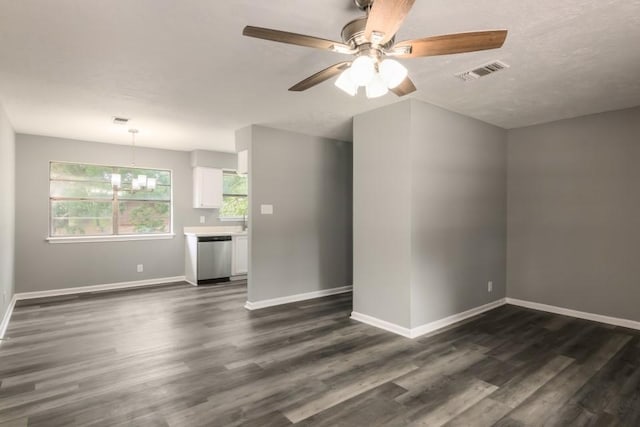 1314 Garrett St, Brenham, TX 77833 - unfurnished living room with dark wood-style flooring, a ceiling fan, and a chandelier
