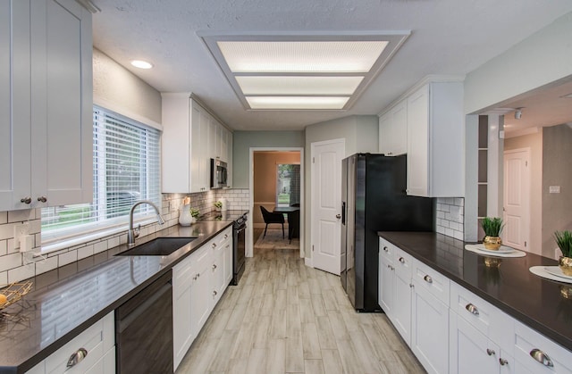 22523 Wildwood Grove Dr, Katy, TX 77450 - kitchen featuring stainless steel appliances, dark countertops, and backsplash