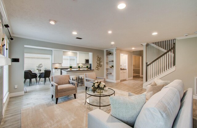 22523 Wildwood Grove Dr, Katy, TX 77450 - living area featuring ornamental molding, recessed lighting, stairs, and light wood-style flooring