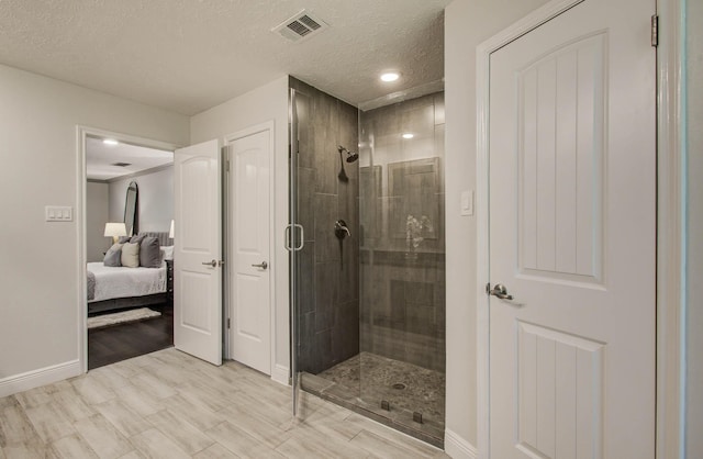 22523 Wildwood Grove Dr, Katy, TX 77450 - ensuite bathroom with a shower stall, a textured ceiling, recessed lighting, and wood finished floors