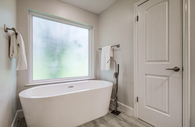 22523 Wildwood Grove Dr, Katy, TX 77450 - full bath with a freestanding tub and wood finished floors