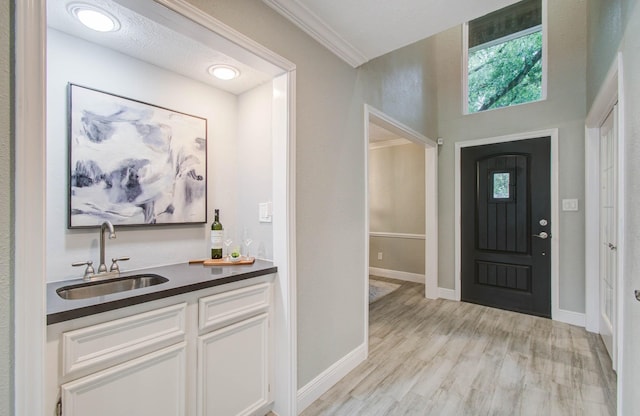 22523 Wildwood Grove Dr, Katy, TX 77450 - entryway featuring light wood-style floors and wet bar