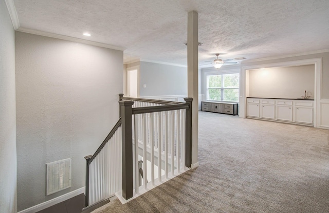 22523 Wildwood Grove Dr, Katy, TX 77450 - corridor featuring an upstairs landing, ornamental molding, a textured ceiling, and carpet floors