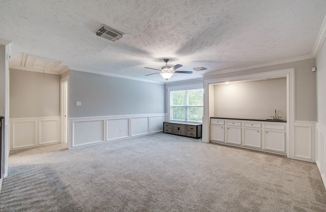 22523 Wildwood Grove Dr, Katy, TX 77450 - unfurnished room featuring attic access, a decorative wall, ornamental molding, ceiling fan, and a wainscoted wall