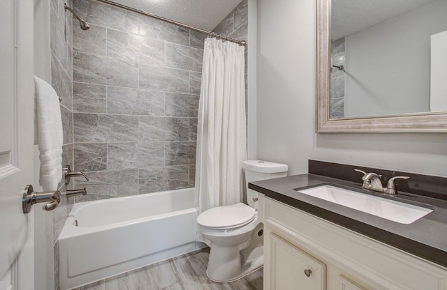22523 Wildwood Grove Dr, Katy, TX 77450 - bathroom with vanity, shower / bath combo, a textured ceiling, and wood finished floors