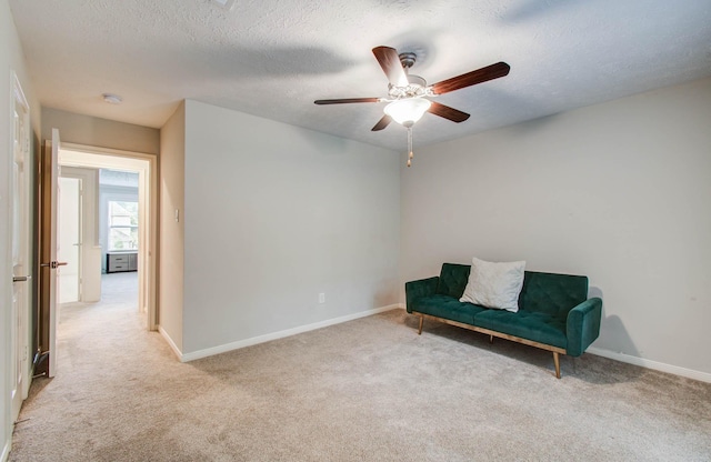 22523 Wildwood Grove Dr, Katy, TX 77450 - sitting room with light colored carpet, a ceiling fan, and a textured ceiling