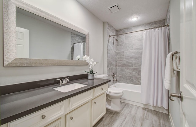22523 Wildwood Grove Dr, Katy, TX 77450 - full bathroom with vanity, shower / bathtub combination with curtain, wood finished floors, and a textured ceiling