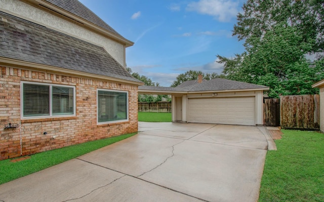 22523 Wildwood Grove Dr, Katy, TX 77450 - view of property exterior with a shingled roof, a garage, concrete driveway, and brick siding