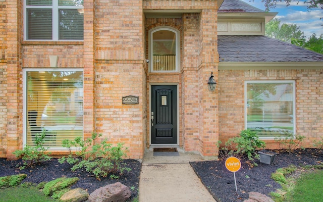 22523 Wildwood Grove Dr, Katy, TX 77450 - view of exterior entry with brick siding and roof with shingles