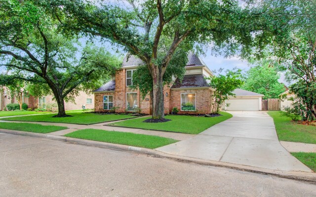 22523 Wildwood Grove Dr, Katy, TX 77450 - traditional-style house featuring brick siding, driveway, and a garage