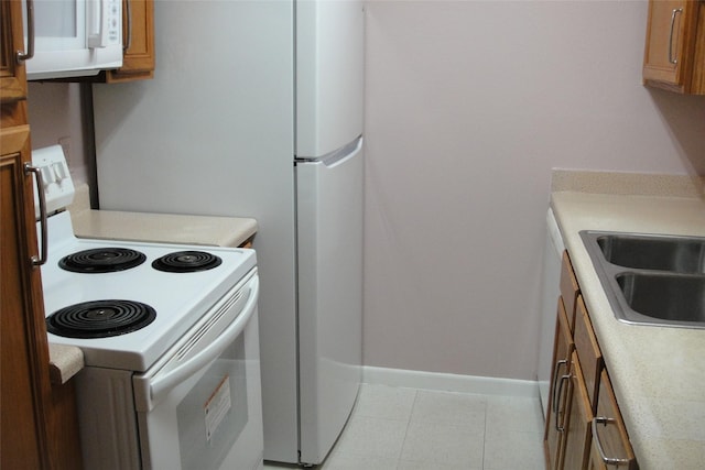 10110 Forum W Dr Unit 202, Houston, TX 77036 - kitchen with white appliances, light countertops, and brown cabinets
