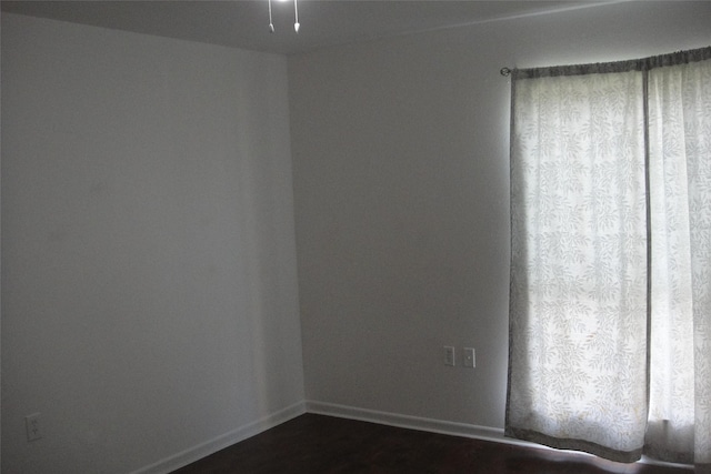 10110 Forum W Dr Unit 202, Houston, TX 77036 - unfurnished room with baseboards and dark wood-type flooring