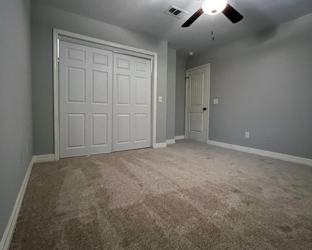 575 Hartman Rd, Silsbee, TX 77656 - unfurnished bedroom featuring carpet, a closet, and a ceiling fan
