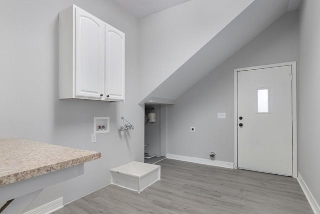 575 Hartman Rd, Silsbee, TX 77656 - laundry room featuring cabinet space, hookup for a washing machine, light wood-type flooring, and electric dryer hookup