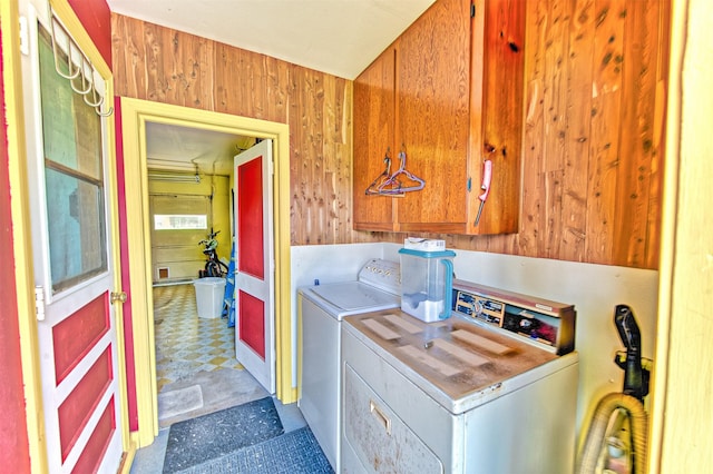 1726 Wilde Rock Way, Houston, TX 77018 - laundry room with independent washer and dryer, tile patterned floors, wooden walls, and cabinet space