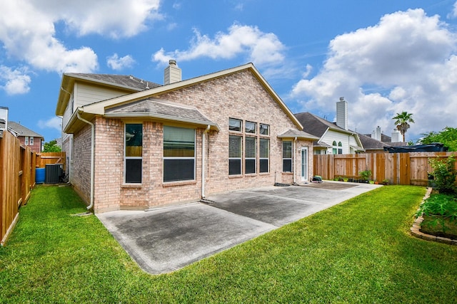 5823 Lundwood Ln, Houston, TX 77084 - rear view of house featuring a patio area, a fenced backyard, brick siding, and a chimney