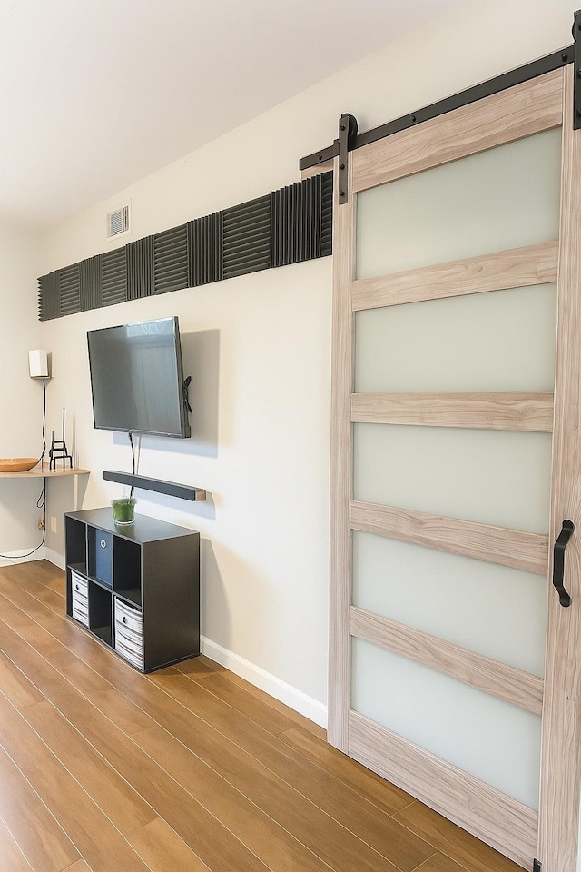 13022 Trail Hollow Dr Unit 3022, Houston, TX 77079 - interior space featuring a barn door and wood finished floors