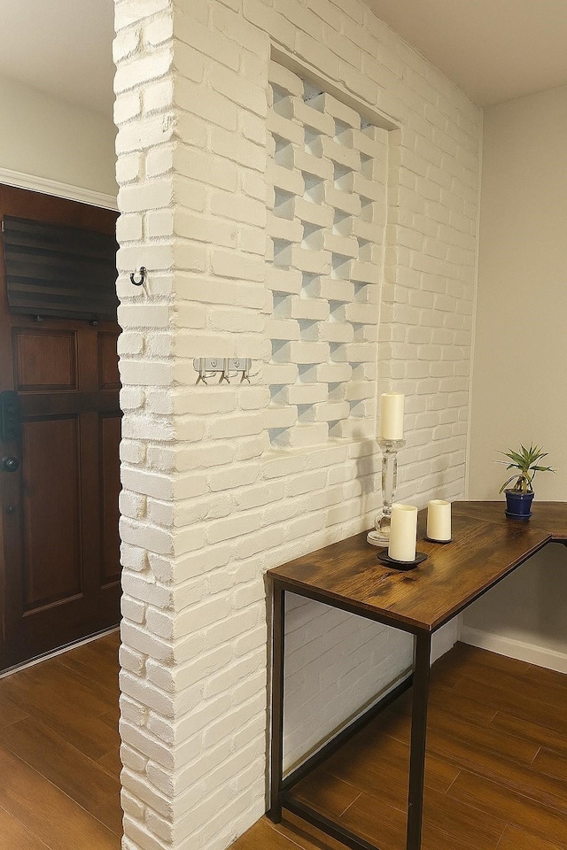 13022 Trail Hollow Dr Unit 3022, Houston, TX 77079 - detailed view of wood finished floors and brick wall