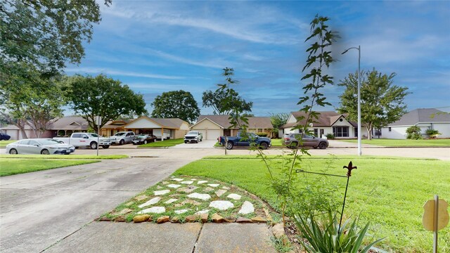 2010 Wildwood Dr, Deer Park, TX 77536 - view of grassy yard with a residential view and driveway